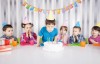 Picture of a boy blowing out candles on a cake
