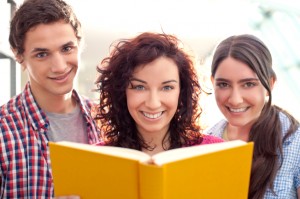 Mon Holding a book with Teenage Children